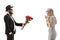 Bearded man in a suit giving a bouquet of red roses to a surprised woman