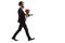 Bearded man in a suit walking with a bunch of red roses