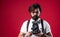 bearded man in suspenders making vintage photo. elegant businessman hold retro camera. journalist use old technology