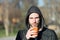 Bearded man with takeaway drink in sunny park. Macho in hood hold disposable coffee cup. Coffee or tea mood. Drink and food outdoo