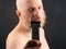 Bearded man with trimmer to adjust beard in hand