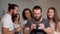 Bearded man using virtual reality glasses with his friends