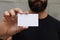 Bearded Man Wearing Casual Black Tshirt Showing Blank White Business Card.Blurred Background Ready Corporate Private