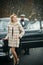 Bearded man and woman in fur coat. Escort of girl by security. Retro collection car and auto repair by mechanic