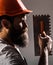 Bearded man worker, beard, building helmet, hard hat. Plastering tools. Builders in hard hat, helmet
