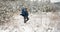 Bearded mature man hiking in snowy forest