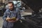 Bearded mechanic working at car service station