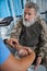 Bearded military man is consulting with specialist in rehabilitation center