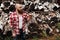 Bearded mohawk man standing near firewood woodshed