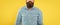 Bearded mustached man crop view in denim shirt yellow background, beard