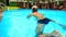 Bearded Old Man Swims along Oval City Swimming Pool