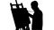 Bearded painter drawing a painting by oil paints