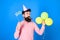 Bearded party entertainer at kids celebration, International children day concept. Man with bright balloons, paper