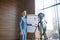 Bearded rich businessman standing near smart board and filming video