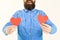 Bearded romantic man with long beard holding red paper hearts