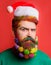 Bearded Santa man with Christmas decorated beard. Santa man with decorated beard for New Year party. Closeup portrait of