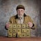 Bearded senior man with antique apothecary cabinet