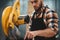 Bearded service mechanic working on electrical grinding machine in service station. Servicing of machines. Workflow at the factory