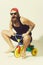 Bearded shouting man on colorful bicycle toy in sunglasses, cap