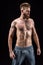 Bearded sportsman posing and standing isolated on black in studio