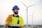 Bearded technician engineer of windmill and renewable energy industry working and looking the turbine to reapir and fix