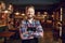 Bearded waiter barista bartender standing against the background of the pub bar