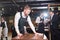 Bearded waiter wiping table in restaurant