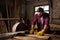 bearded worker in protective googles and gloves using machine saw