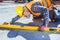 Bearded worker in reflective vest and hardhat working with spirit level at construction site, leveling