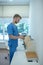 Bearded young doctor putting papers in standing file folder