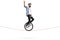 Bearded young man riding a unicycle on a rope and waving