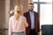 Bearded young psychologist smiling while greeting patient