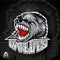 Beast head with bared teeth. Logo for any sport team wolves on dark