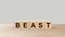 Beast - word wooden cubes on table horizontal over gray background HD