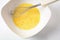 Beaten egg yolks in a bowl with whisk