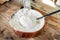 Beaten eggs and apples for making homemade marshmallows, marshmallows and meringue in a copper large bowl on a wooden old table.