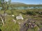 Beatiful camping spot in northern landscape in Swedish Lapland with turquoise blue Vuojatadno river, birch tree forest