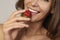 Beatiful girl with Perfect smile eat red strawberry white teeth and healthy food