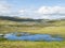 Beatiful northern artic landscape, tundra in Swedish Lapland with vivid blue lakes and pond, lush green grass, hills and