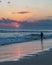 Beatiful sunset and silhouette of a man on Seminyak beach