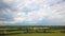 Beatifull grass field, country summer dark stormy clouds background