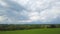 Beatifull grass field, country summer dark stormy clouds background