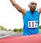 Beating his previous record. Cropped close up of a victorious athlete reaching the end of the race.