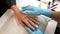 Beautician applying moisturizing cream on her client`s hands after a manicure.