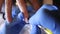 Beautician applying white color gel with a brush on girl nail in a beauty salon