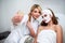 Beautician blogger making selfie with client after applying facial mask for healthy skin. Attractive women making photos