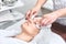 Beautician cleans the face with napkins. woman at spa procedure