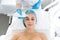 The beautician cleans the patient`s skin with an ultrasound scrubber. A young girl is undergoing a course of spa treatments in th