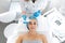 The beautician cleans the patient`s skin with an ultrasound scrubber. A young girl is undergoing a course of spa treatments in th