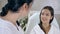 Beautician consults woman about facial botox injection in beauty salon closeup